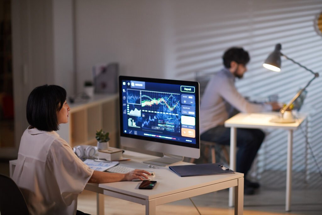 Office workers analyzing data with AI tools reflecting changes in the US labor market