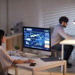 Office workers analyzing data with AI tools reflecting changes in the US labor market